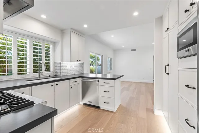 a view of a livingroom with wooden floor and a ceiling fan
