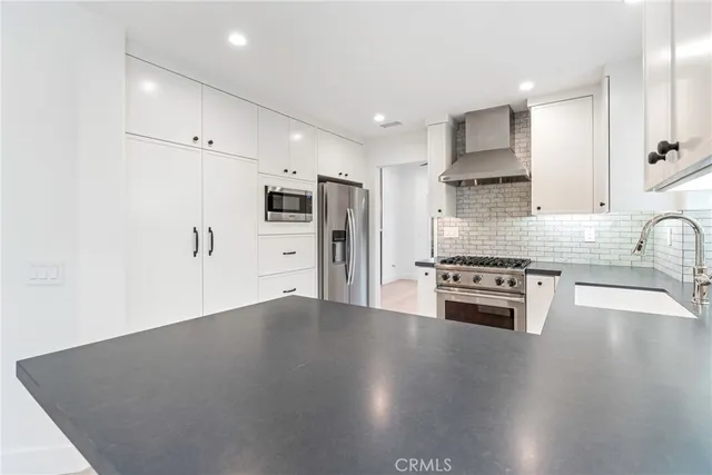 a view of an empty room with a window and fire place