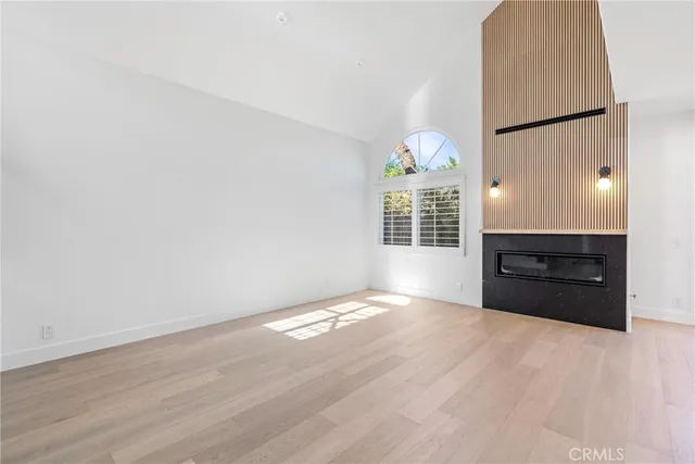 a view of a hallway with entryway and stairs