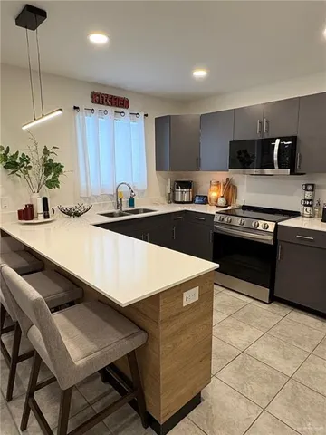 a kitchen with a dining table chairs and kitchen view