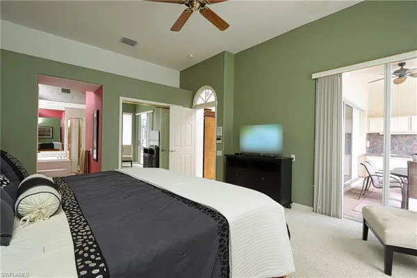 a bedroom with a bed and a chair