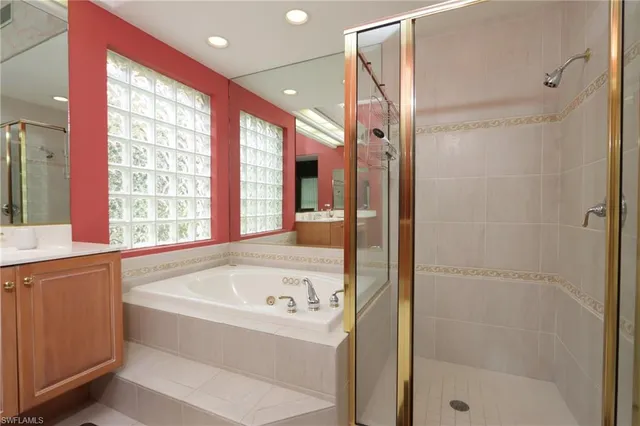 a bathroom with a bathtub and a shower