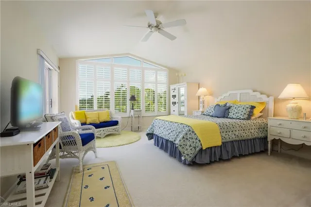 a spacious bedroom with a bed and wooden floor