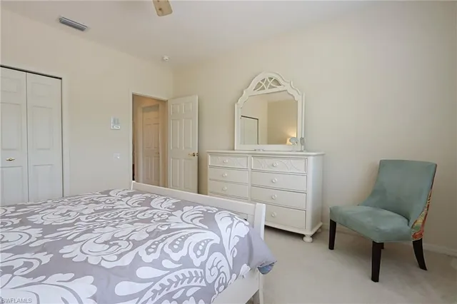 a bedroom with a bed and a chair