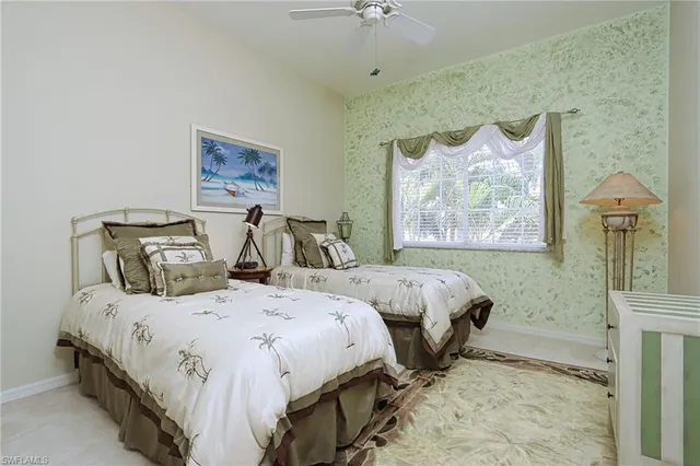 a bedroom with two beds and a painting on the wall