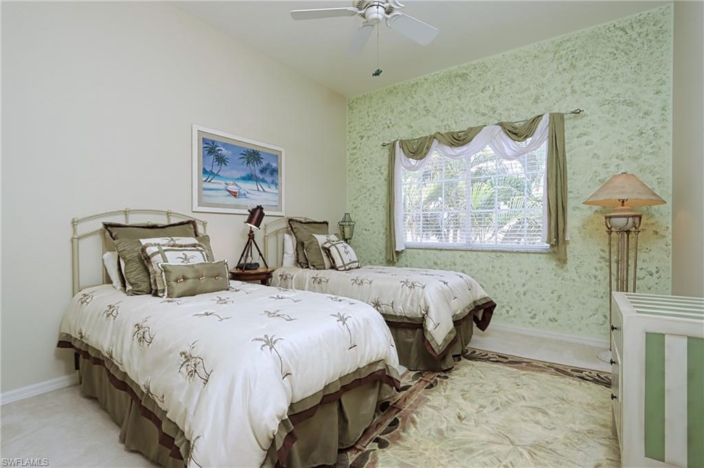 5901 Ashford Lane Naples, FL 34110 - Photo 19 of 30 a bedroom with two beds and a painting on the wall