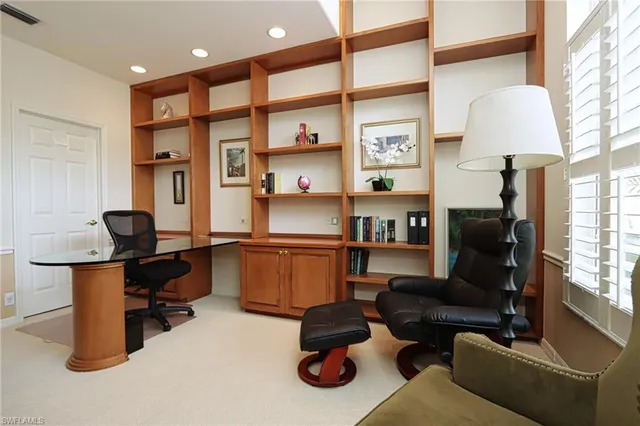 a livingroom with workspace couch and a window