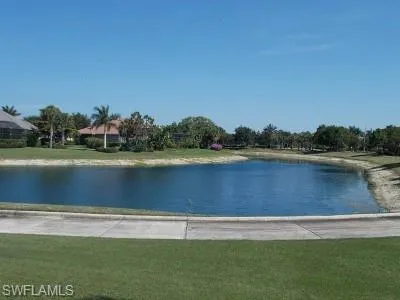 a view of a lake with houses in background