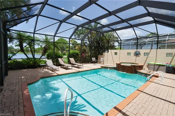a view of a patio with table and chairs under an umbrella