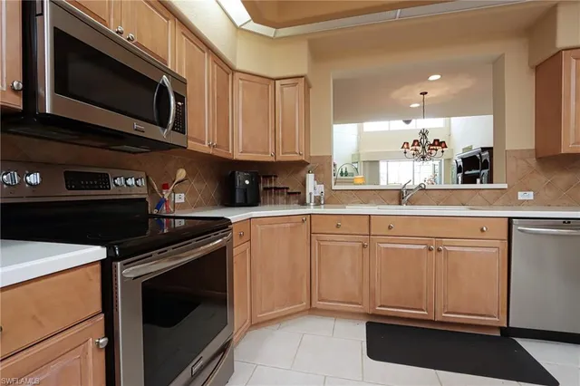 a kitchen with stainless steel appliances granite countertop a stove microwave and sink