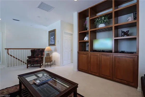 a living room with furniture a rug and a flat screen tv