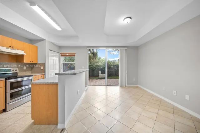 a view of a kitchen with a sink and a large window