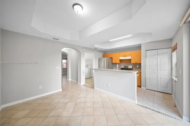 a kitchen with a sink a refrigerator and a stove