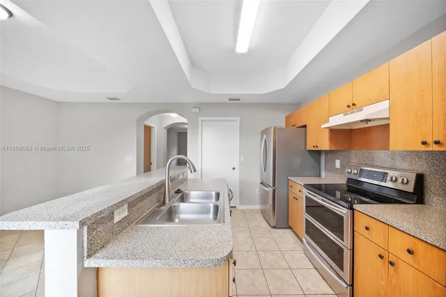 a view of a kitchen from the hallway