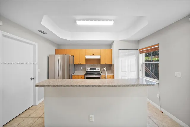 a utility room with cabinets washer and dryer