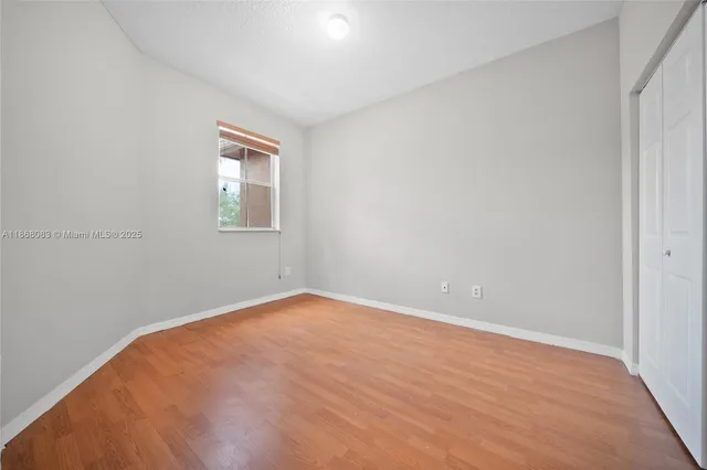 a view of a room with wooden floor