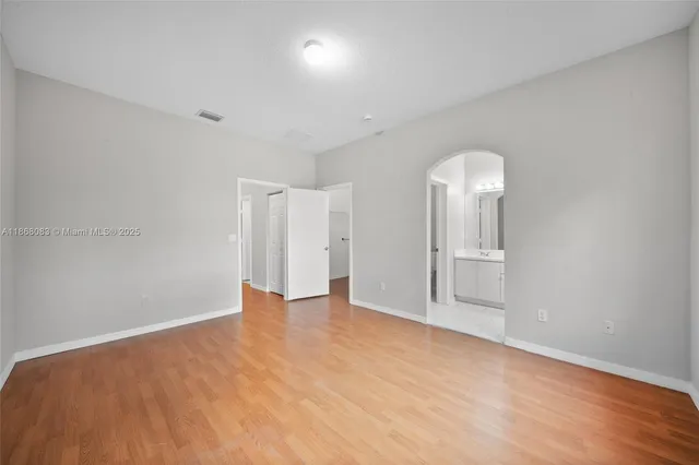 a bathroom with a granite countertop sink mirror vanity and toilet