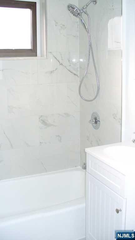 501 Linwood Drive, Unit 5J Fort Lee, NJ 07024 - Photo 13 of 23 a bathroom with a bath tub a shower and a sink