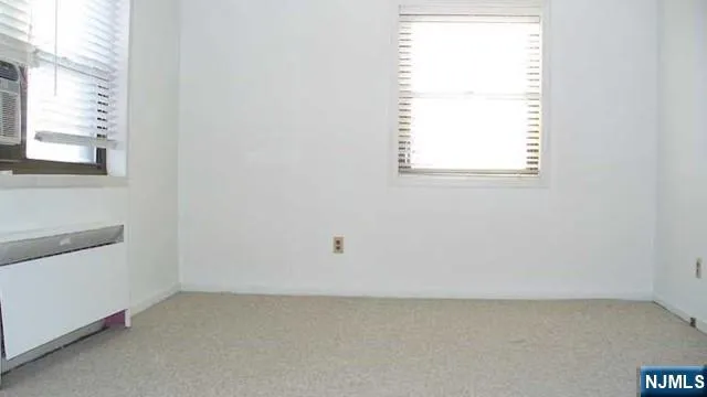 a view of an empty room and a window