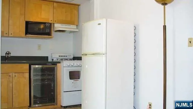 a kitchen with a refrigerator and a stove