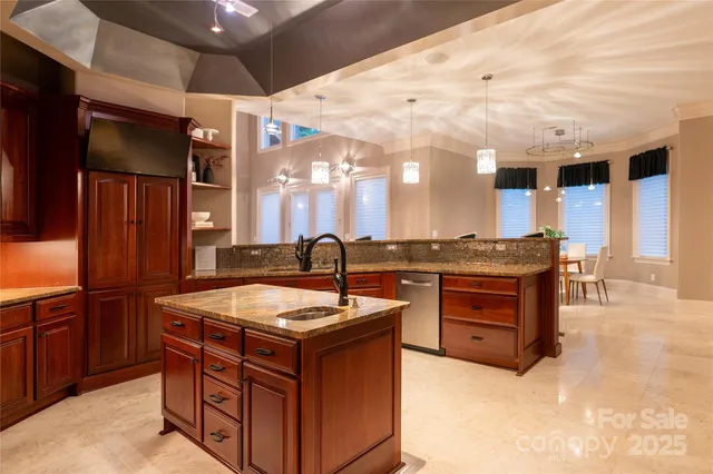 a kitchen with stainless steel appliances granite countertop a sink and a stove