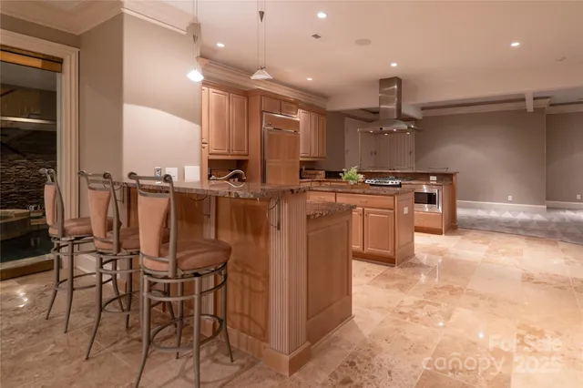 a kitchen with stainless steel appliances a table a chairs a stove and a refrigerator