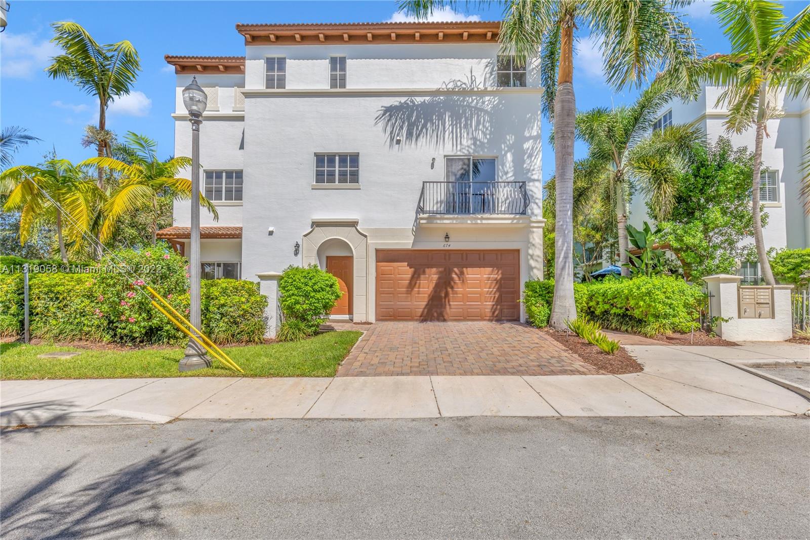 674 Northwest Library Commons Way, Unit 674 Boca Raton, FL 33432 - Photo 20 of 20 a front view of a building with garden