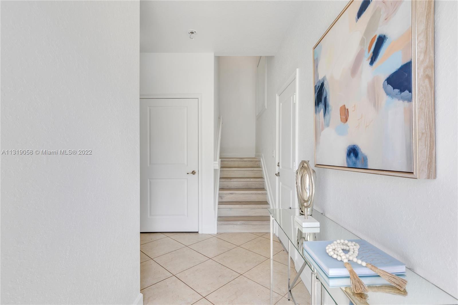 674 Northwest Library Commons Way, Unit 674 Boca Raton, FL 33432 - Photo 5 of 20 a view of entryway with white walls