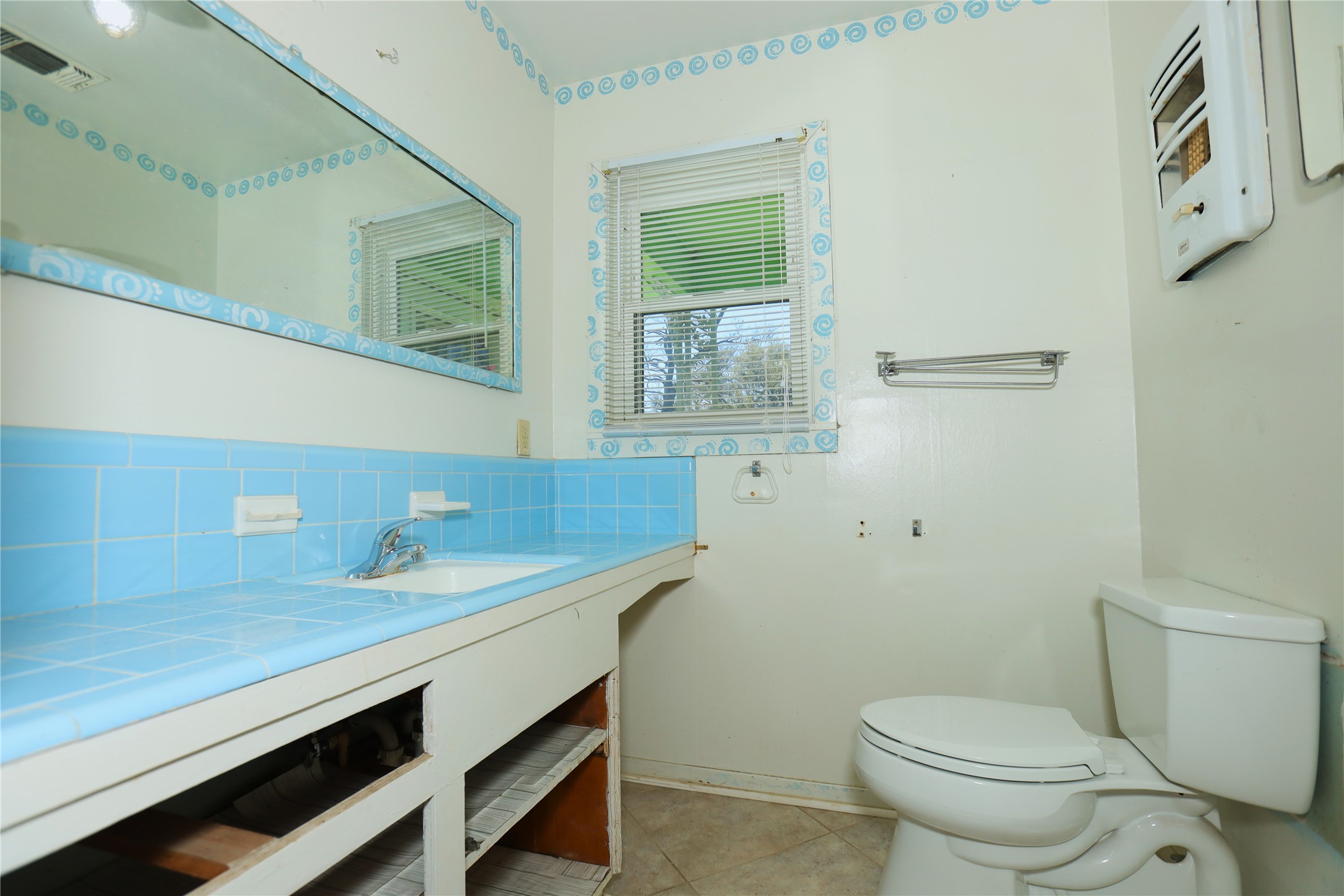 700 Wesley Drive Clute, TX 77531 - Photo 14 of 27 a bathroom with a sink a toilet and mirror