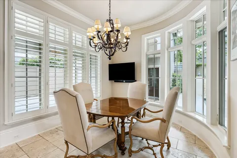 a view of a dining room with furniture wooden floor and chandelier