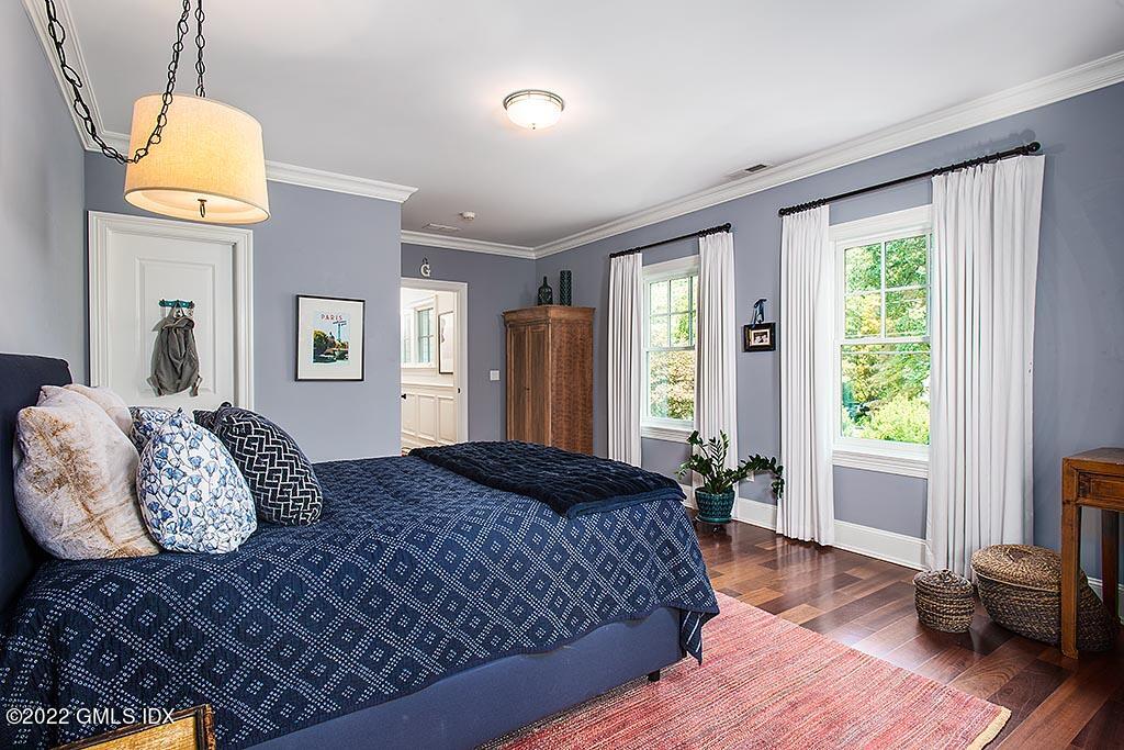 26 Hendrie Avenue Riverside, CT 06878 - Photo 15 of 37 a bedroom with a bed and wooden floor