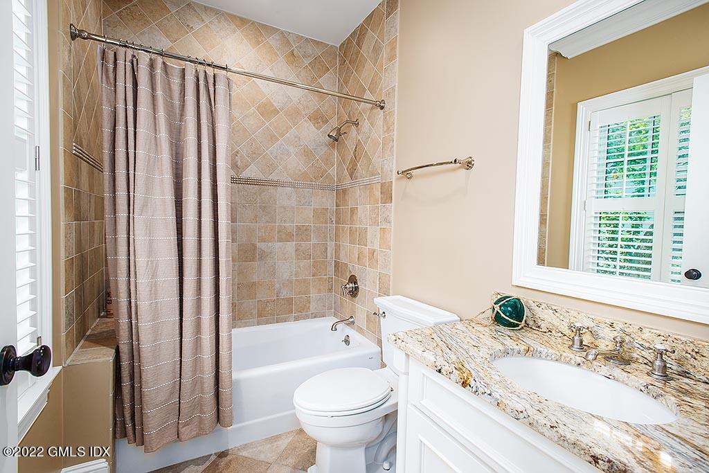 26 Hendrie Avenue Riverside, CT 06878 - Photo 16 of 37 a bathroom with a granite countertop sink toilet and shower