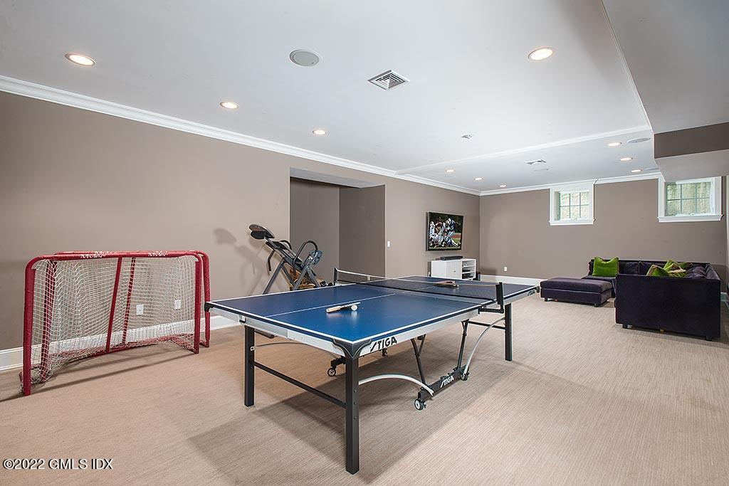 26 Hendrie Avenue Riverside, CT 06878 - Photo 23 of 37 a living room with furniture a table and a flat screen tv