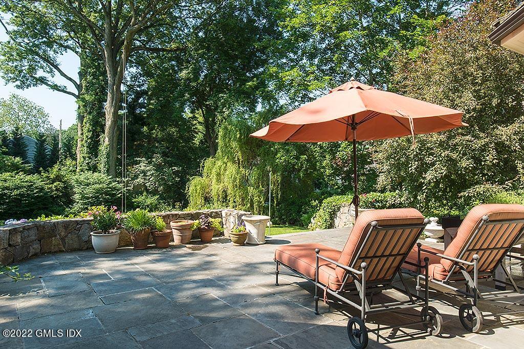 26 Hendrie Avenue Riverside, CT 06878 - Photo 27 of 37 a view of a patio with table and chairs under an umbrella