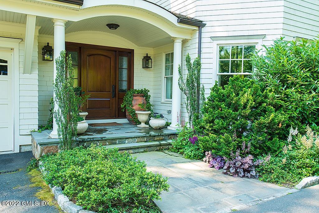 26 Hendrie Avenue Riverside, CT 06878 - Photo 33 of 37 a front view of a house with a garden