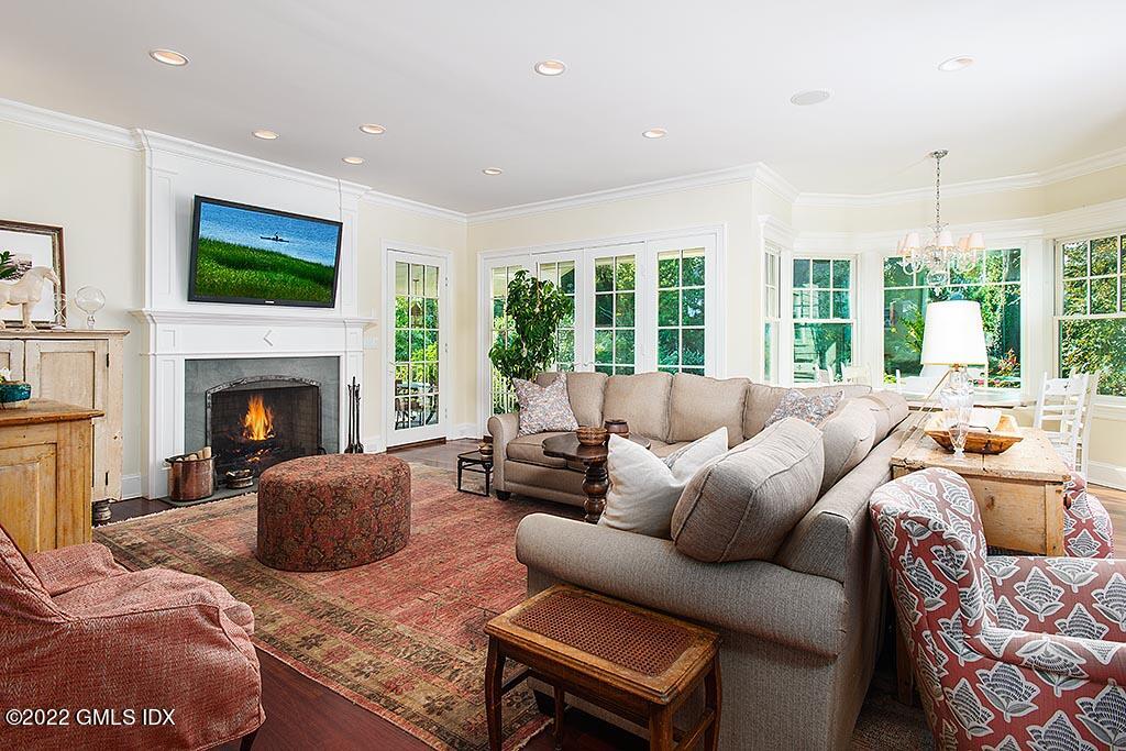 26 Hendrie Avenue Riverside, CT 06878 - Photo 5 of 37 a living room with furniture a flat screen tv and a fireplace