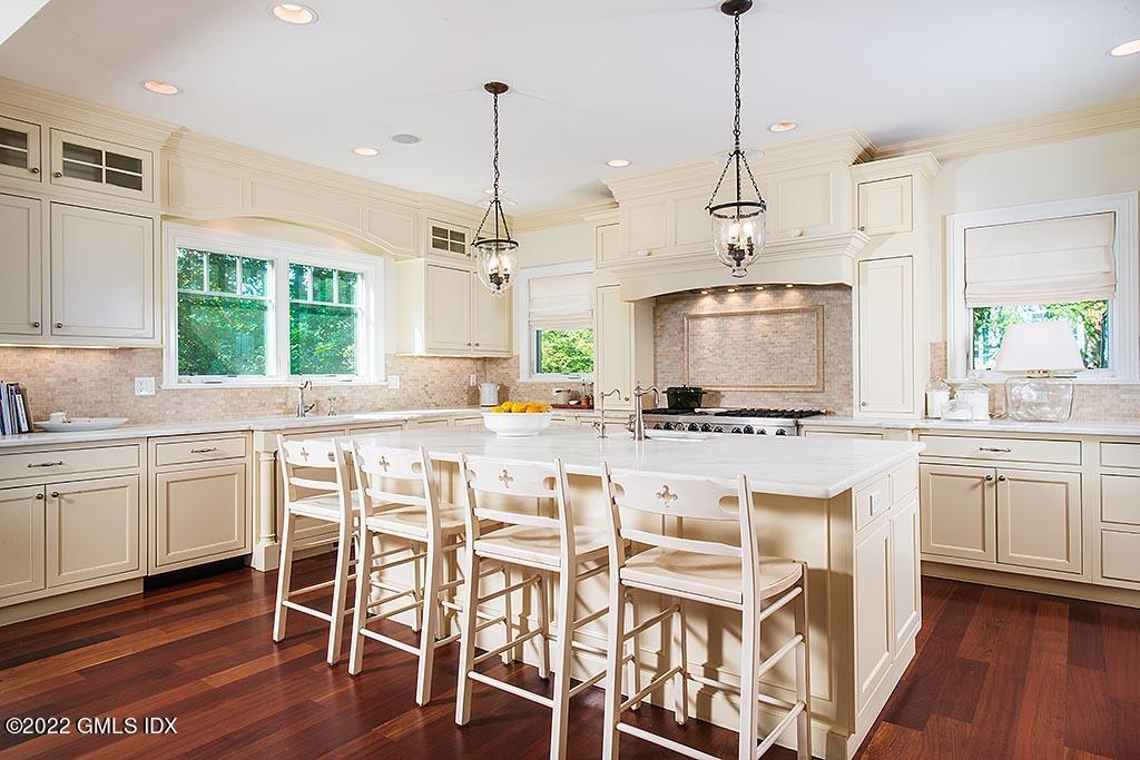 26 Hendrie Avenue Riverside, CT 06878 - Photo 7 of 37 a kitchen with a sink and chairs