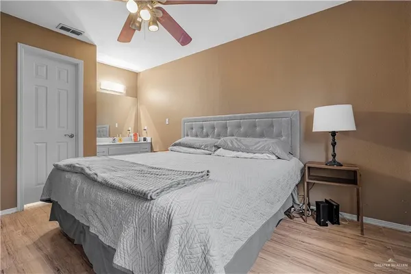 a bedroom with a bed and a lamp on table