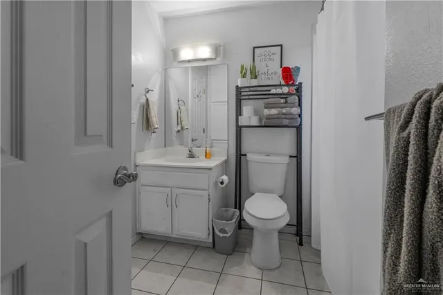 a bathroom with a sink toilet and a mirror
