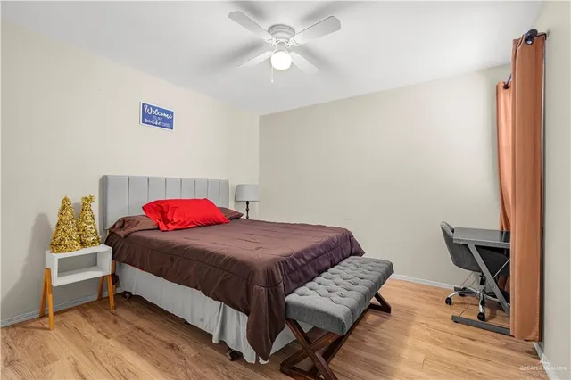 a bedroom with a bed desk and a window