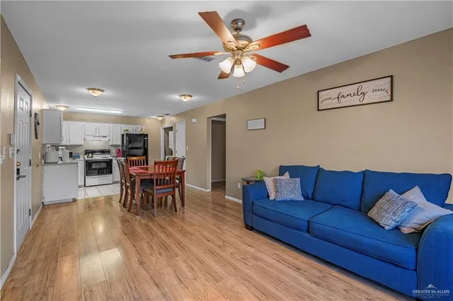a living room with furniture and kitchen view