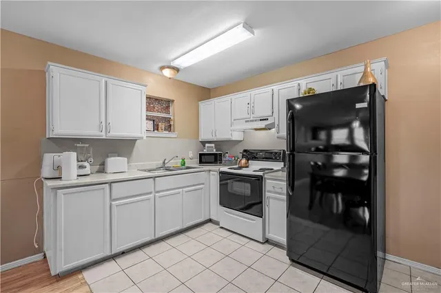 a kitchen with a sink cabinets and appliances