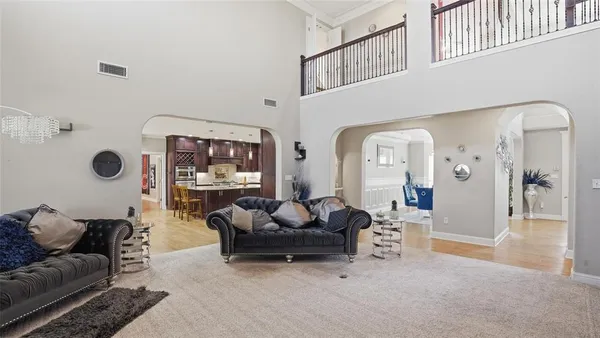 a living room with furniture a rug and white walls