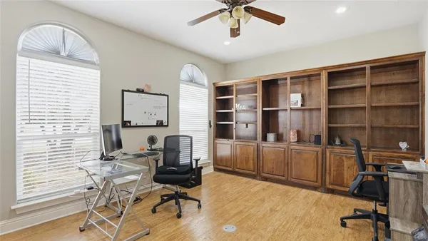 a view of a workspace with furniture and a window