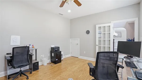a view of a workspace with furniture and a window