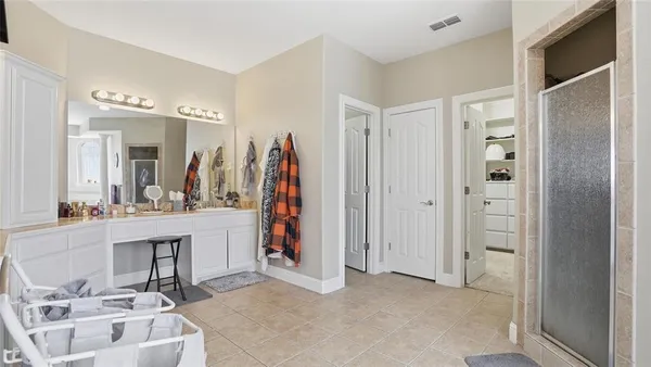 a view of a bathroom with dual sinks
