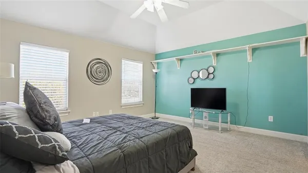 a bedroom with a bed and a television