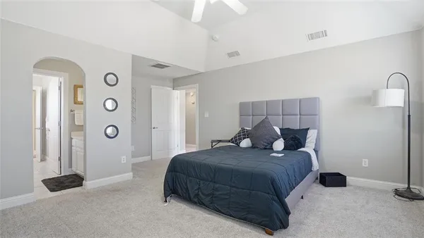 a bedroom with a bed and a chandelier
