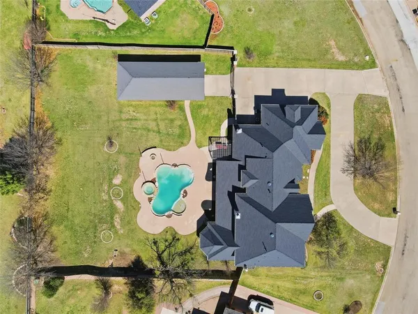 an aerial view of a house with a swimming pool