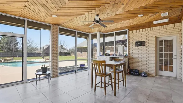 a room with patio furniture and a large window